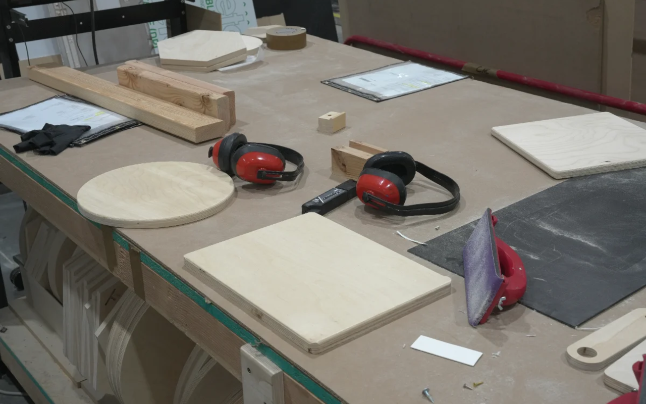 Frame being assembled or finished — corner joinery, hands working